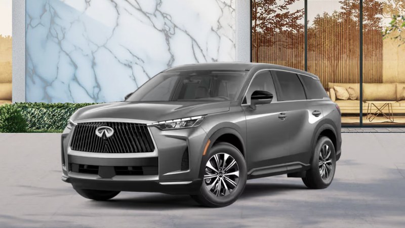 2027 INFINITI QX60 PURE in graphite gray, front three-quarter view on a modern paved driveway