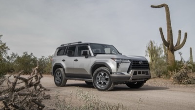 2026 Lexus GX 550 Overtrail in Atomic Silver, off-road wheels and roof rack on a gravel clearing